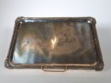 an old silver tray with a handle on a white surface