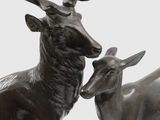 a statue of two animals that are standing next to each other