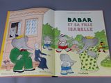 an open book with a picture of an elephant and other animals