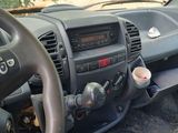 a steering wheel and dashboard of a vehicle with a cup of coffee in it