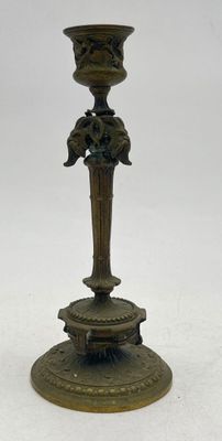 an image of a bronze candle holder with a bird on it