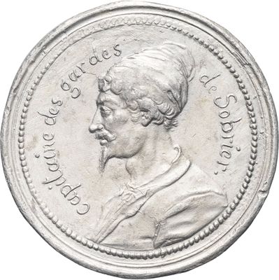gros plan d'une pièce d'argent sur laquelle figure un homme