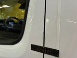 a close up of a white truck with a black sticker on it
