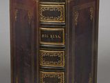 an old book that is open on a table