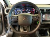 the interior of a car with a steering wheel and dashboard controls
