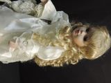 a doll that is laying down on a black surface