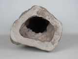 a white object with a hole in it on a white surface