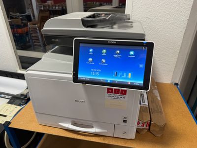 an image of a printer on a desk with a tablet