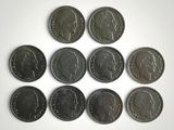 six different british coins are arranged in a circle on a white surface