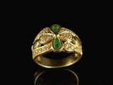 a gold ring with emerald and diamonds