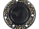 an image of a black plate with white flowers and leaves