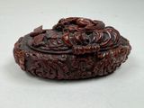 a small box with a dragon on it on a table