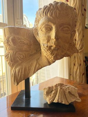 a statue of a man with a shell on a table