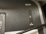 a cell phone sitting on top of a printer with a blue marker
