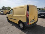 a yellow van parked in a parking lot next to other cars
