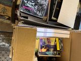 a cardboard box full of books on the floor