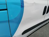a blue and white van parked on the side of the road