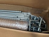 a cardboard box with a bunch of metal pipes in it