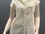 female mannequin dressed in beige shirt and pants on a mannequin