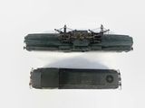 two model trains sitting side by side on a white surface