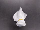 a white flower floating on top of a black surface