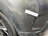 the front bumper of a car with a sticker on it ' s bumper