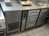 a kitchen with stainless steel counter tops and a sink