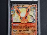 a close up of a pokemon card on a black surface