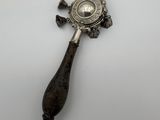 a silver spoon with a wooden handle on a white surface