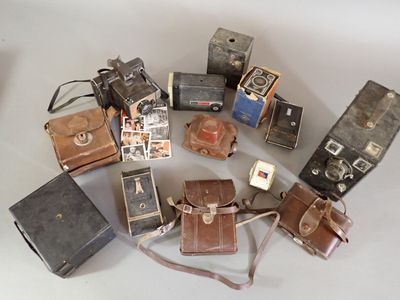 a lot of old cameras sitting on a table