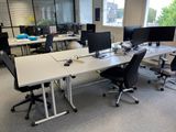 many computers on the desks in this office