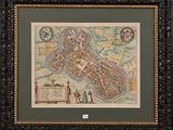 a framed map of the city of london in a wooden frame
