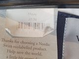 a label on a pair of scissors next to a pair of scissors