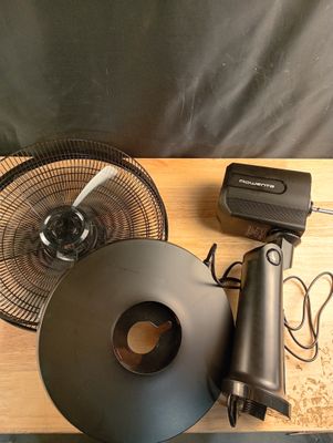 a picture of a table with a fan and other items on it