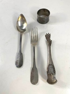 four spoons and a fork on a white table
