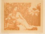 an old photo of a nude woman sitting on the ground