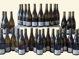 many bottles of wine that are sitting on a table