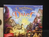 two board games sitting on top of a table next to each other