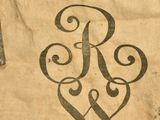 a bag with a monogram on it sitting on a table