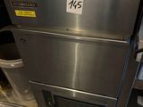 a stainless steel oven that has a trash can underneath it
