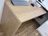 a computer desk with a keyboard and a monitor on it