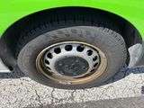 a close up of a tire on a green car