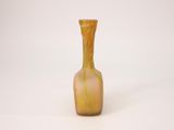 a glass vase that is sitting on a white surface