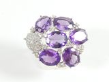 a close up of a ring with amethorate and diamonds