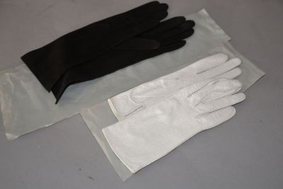 a pair of gloves sitting on a table next to a bag