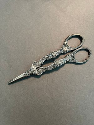 a pair of scissors sitting on top of a table