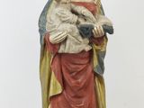 statue of a woman holding a cat in her arms