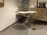 a small table with a soccer ball on it in the corner of a room