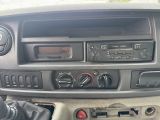 a car dashboard with a radio and a steering control