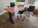 a desk with two chairs and a sign on the wall